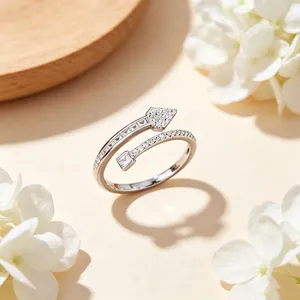Detailed view of a silver arrow and nail open ring with sparkling cubic zirconia inlay.