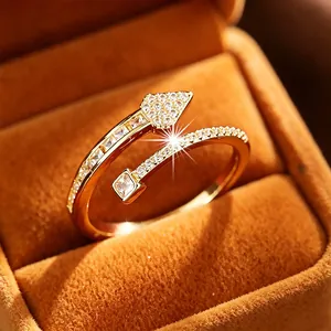Elegant gold arrow and nail open ring encrusted with sparkling cubic zirconia.