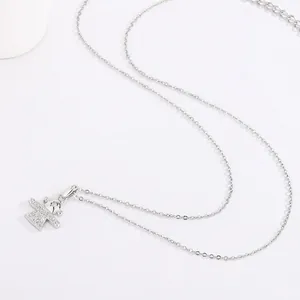 Detailed view of titanium steel necklace featuring a sparkling angel character pendant