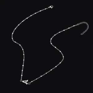 Detailed view of silver faux pearl chain necklace with capital letter A pendant