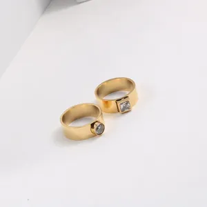 Close-up of 18k gold plated stainless steel rings with square and round zircons