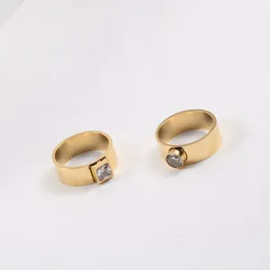 Detail view of 18k gold plated titanium steel rings with square and round zircons.