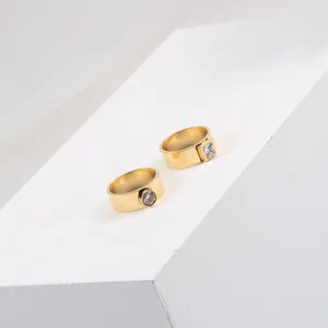 Detailed macro view of square and round zircon rings in 18k gold plated titanium steel