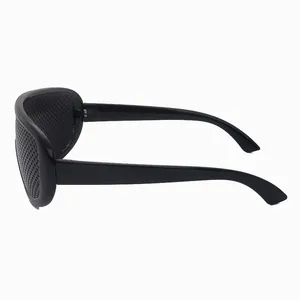 Black pinhole glasses for vision correction shown from a side perspective