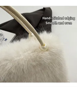 Close-up of white plush handbag featuring hand-stitched handle and elegant pearl accent