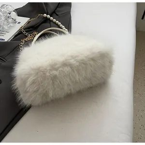 Close-up of plush white handbag with elegant pearl chain and soft faux fur texture