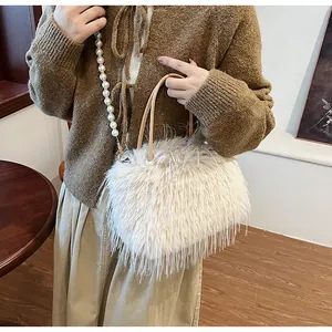 Close-up of a stylish beige plush faux fur handbag with an elegant pearl shoulder strap