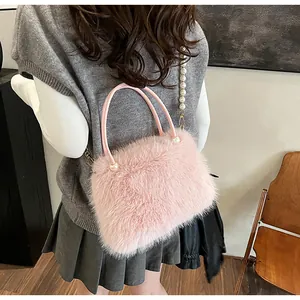 Elegant pink faux fur handbag with pearl chain detail for autumn and winter outfits