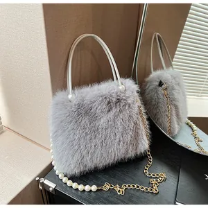Detailed close-up of a gray faux fur handbag with pearl-embellished gold chain strap.