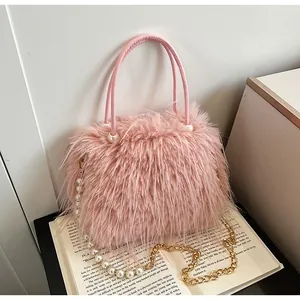 Detailed view of pink faux fur handbag with elegant pearl chain and soft texture.