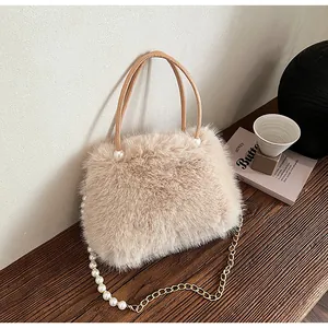 Close-up showing the plush beige texture and elegant pearl chain of the stylish handbag