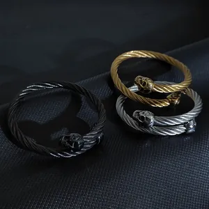 Trio of gothic twisted cable skull bracelets in black gold and silver finishes