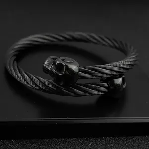 Close-up of black gothic twisted cable bracelet featuring detailed skull head ends.