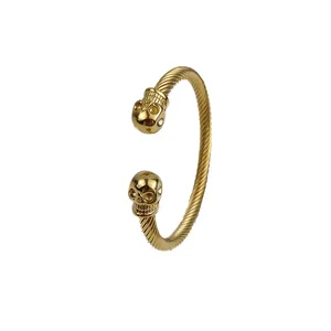 Gothic gold C-shaped twisted rope cable bracelet with double skull heads