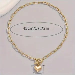 Minimalist gold paperclip chain necklace with heart pendant and OT clasp