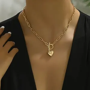 Elegant gold heart pendant necklace featuring paperclip chain and OT toggle clasp design.