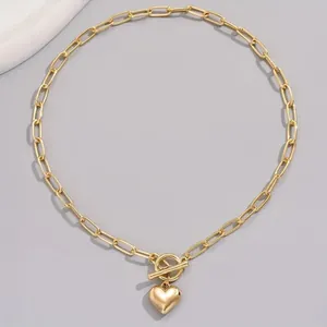 Minimalist gold paperclip chain necklace featuring a heart pendant and OT toggle clasp