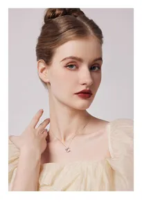 Close-up of elegant crescent moon necklace with zircon on female model