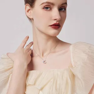 Silver star and moon zircon pendant necklace worn by female model for elegant style