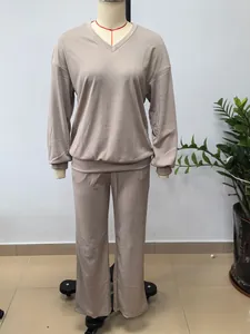 Complete view of a minimalist beige long-sleeve V-neck lounge set on a tailor mannequin