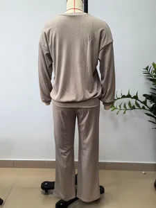 Back view of women's solid color two-piece lounge set with long-sleeve top and pants.