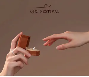 Close-up of a minimalist silver ring in a luxury velvet box being presented as a gift