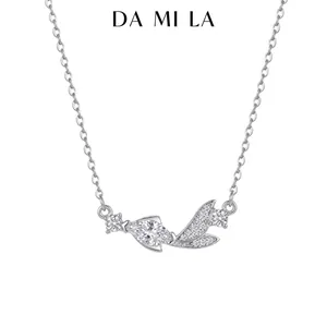 Close-up view of a silver necklace featuring a stylized pendant set with sparkling zircons.