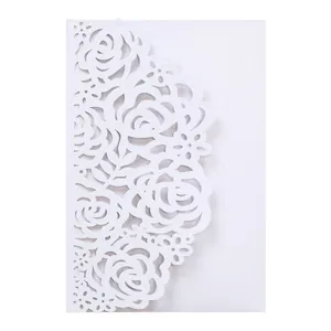 Detailed macro view of white laser-cut rose pattern on elegant wedding invitation
