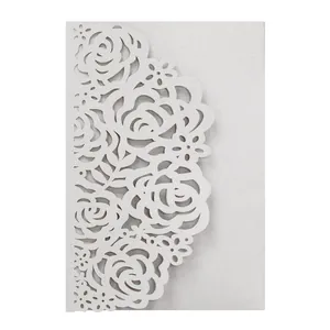 Macro view of elegant laser-cut rose patterns on silver pearlescent invitation card