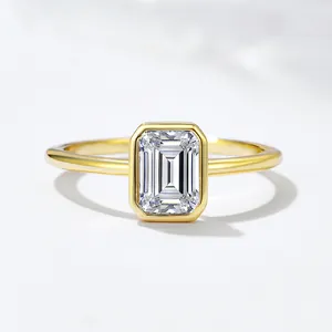 Minimalist S925 silver ring with emerald cut clear zircon in a gold bezel setting