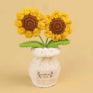 Hand-knitted yellow crochet sunflower potted ornament with a cozy white knitted pot