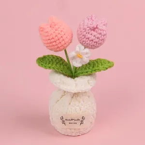 Beautiful handmade pink and peach crocheted tulip flower potted plant in a soft white vase