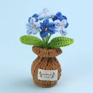 Beautiful handmade blue forget-me-not crochet potted plant with a decorative label