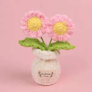 Handmade pink crocheted sunflower bonsai ornament in a white pot for home decoration