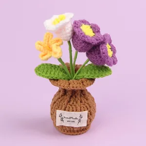Handmade crochet purple and yellow flower potted ornament featuring a cozy knitted pot