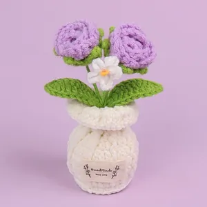 Handmade knitted purple roses and white flower in a crochet pot desktop ornament