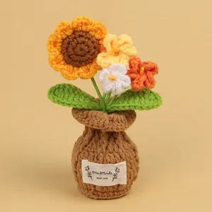 Handmade crochet sunflower and mixed flower potted ornament in a brown knitted vase