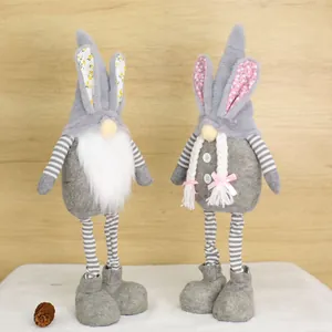 Detailed view of a pair of standing Easter rabbit gnomes with striped legs for home decor.