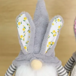 Close-up detail of Easter gnome plush doll with floral rabbit ears and striped sleeves