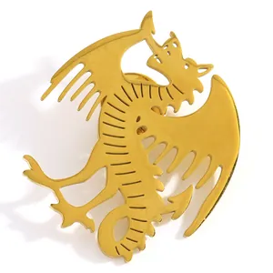 Close-up of a fantasy dragon brooch with a polished gold finish for coat accessories.