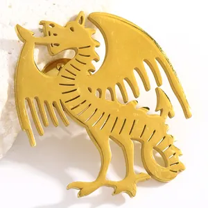 Detailed close-up showing the metallic texture of a golden fantasy dragon brooch