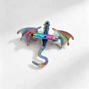 Back view of a fantasy iridescent dragon brooch showing the metallic pin clasp mechanism