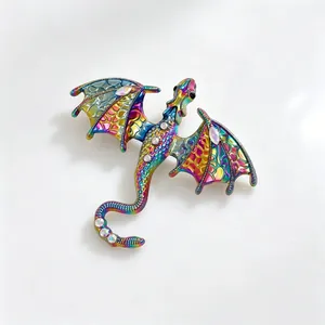 Macro view of an iridescent fantasy dragon brooch featuring colorful scales and rhinestones