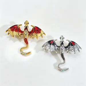 Detailed view of gothic fantasy dragon brooches with intricate enamel wings and gems.