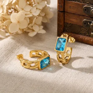 Detailed view of gold-plated stainless steel earrings with faceted rectangular blue zircon