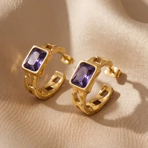 Close-up of gold stainless steel hoop earrings with rectangular purple zircon stones
