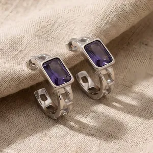 Detailed view of textured stainless steel earrings featuring rectangular purple zircon stones.