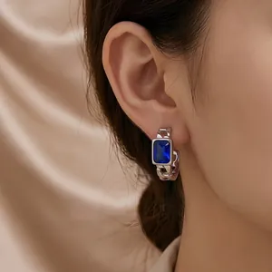 Detailed view of elegant blue rectangular zircon earring with silver chain band