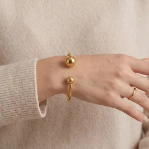 Elegant 18K gold plated stainless steel open cuff bracelet featuring a retro double ball design