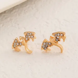 Unique gold flying dragon stud earrings encrusted with sparkling clear rhinestones